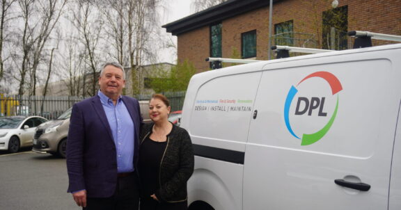 Gary and Fran Dinsdale, founders of DPL Group, standing in front of the company’s van ahead of their retirement.